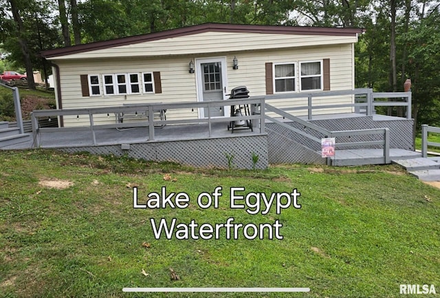 manufactured / mobile home with a front yard and a wooden deck