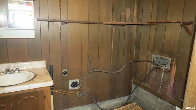 bathroom with wooden walls and vanity