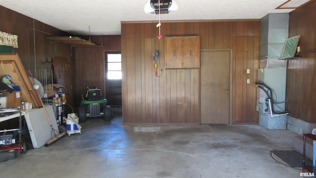 garage with wooden walls and a garage door opener