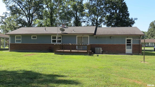 rear view of property featuring a yard and a deck