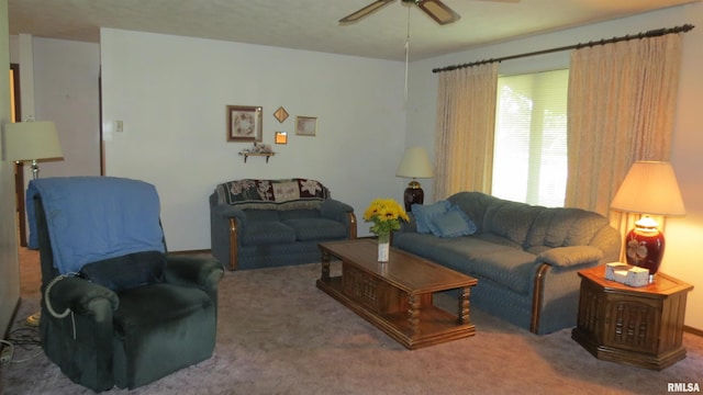 living room with ceiling fan and carpet