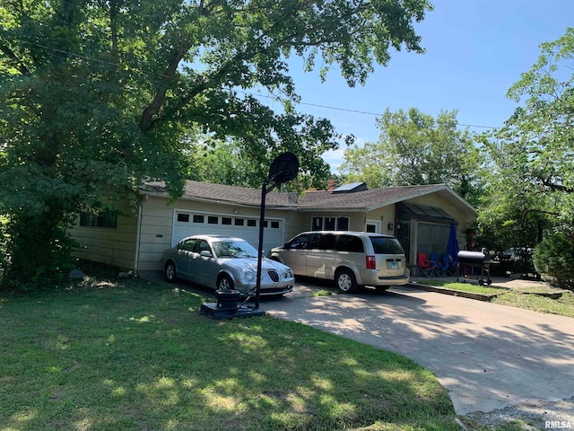 ranch-style house with a front yard and a garage