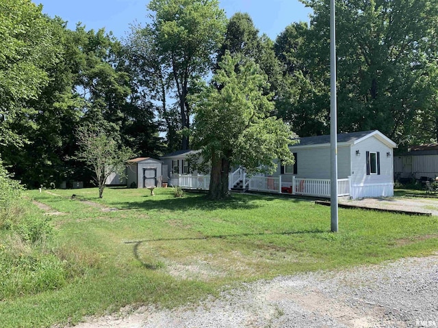 view of front facade featuring an outbuilding, a front lawn, and a shed