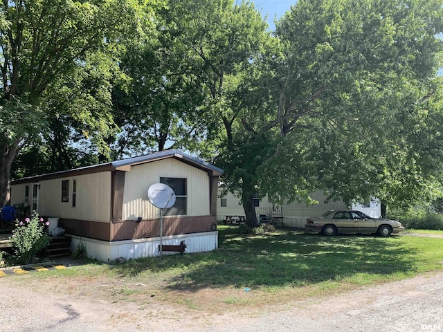 view of side of property with a yard