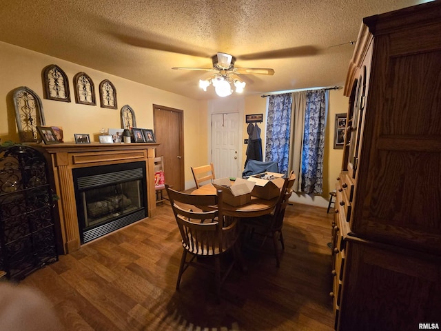 dining area featuring a textured ceiling, ceiling fan, and dark hardwood / wood-style floors