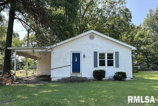 view of front of house with a front lawn and a carport