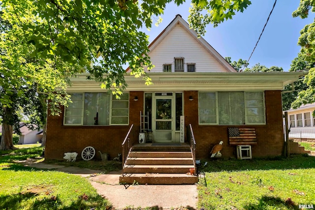 bungalow-style house featuring a front yard