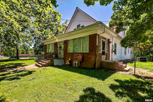 rear view of house with a lawn