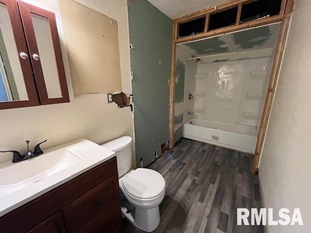 full bathroom featuring vanity, wood-type flooring,  shower combination, and toilet