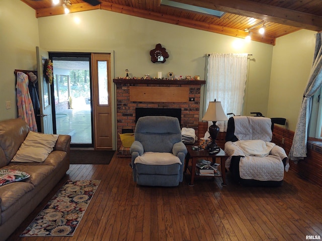 living room featuring lofted ceiling with skylight, a brick fireplace, track lighting, wooden ceiling, and hardwood / wood-style floors