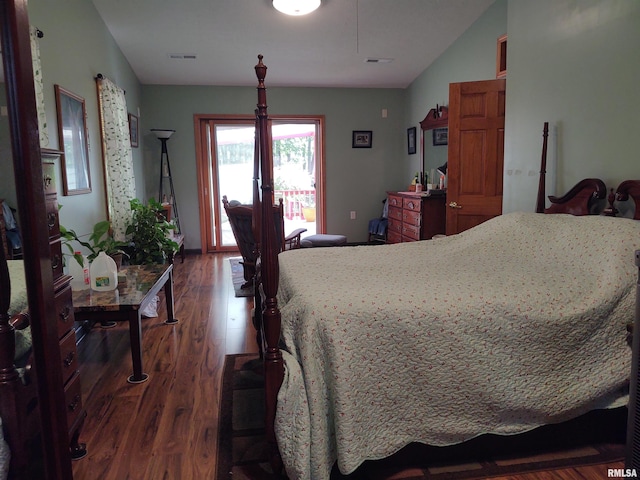 bedroom featuring dark wood-type flooring, lofted ceiling, access to outside, and visible vents