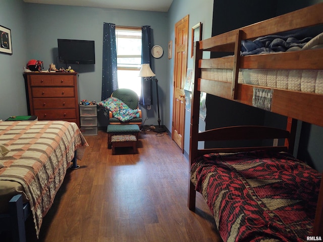 bedroom with dark hardwood / wood-style floors