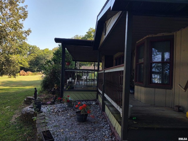 wooden deck featuring a yard