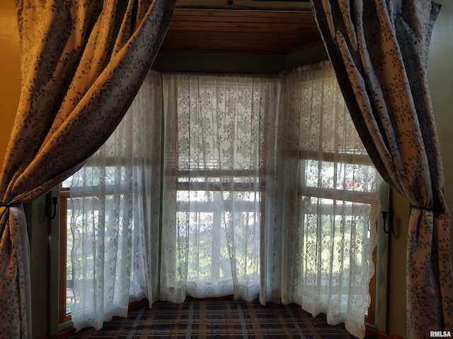 interior details with carpet flooring and wooden ceiling