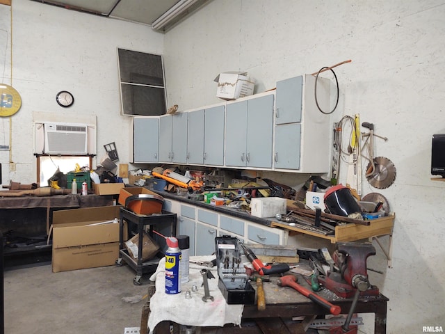 kitchen with a wall unit AC and concrete flooring