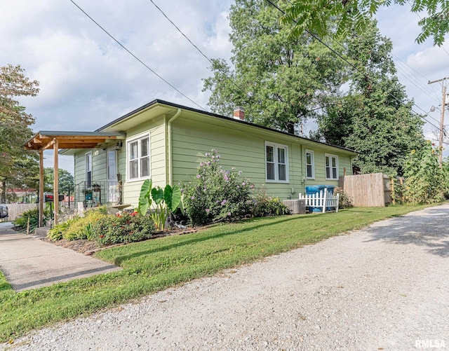 view of side of home featuring a yard