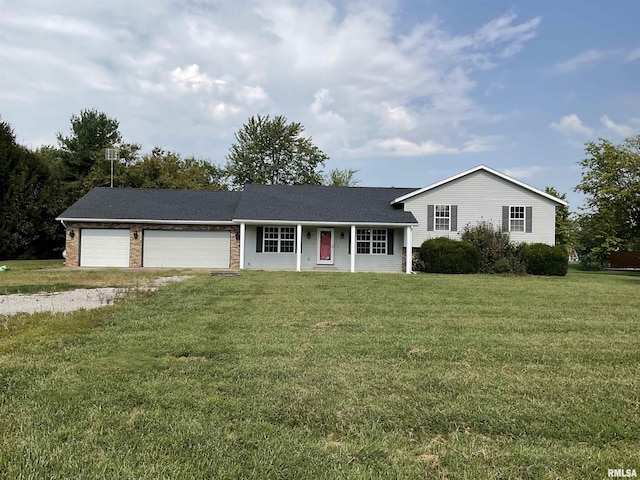 tri-level home with a front lawn, brick siding, driveway, and an attached garage