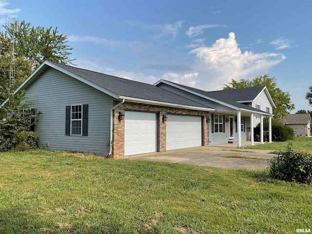 ranch-style home featuring a garage, covered porch, and a front lawn