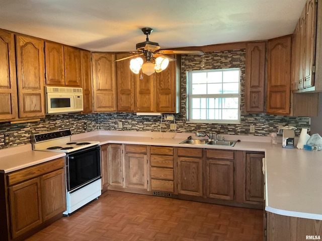 kitchen with white appliances, sink, decorative backsplash, ceiling fan, and dark parquet flooring