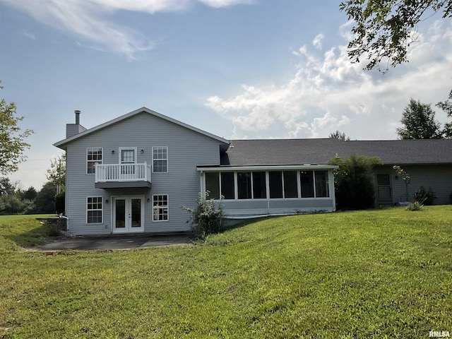 back of house featuring french doors, a patio, a lawn, a sunroom, and a balcony