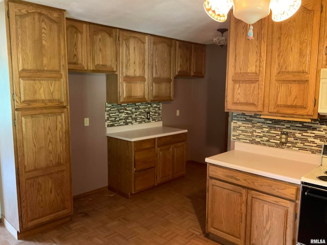 kitchen featuring range with electric stovetop, decorative backsplash, and light parquet flooring