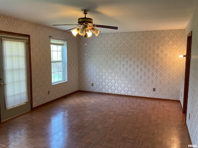 unfurnished room featuring parquet floors and ceiling fan