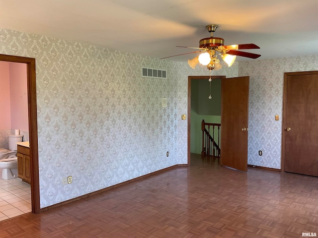 empty room featuring parquet flooring and ceiling fan