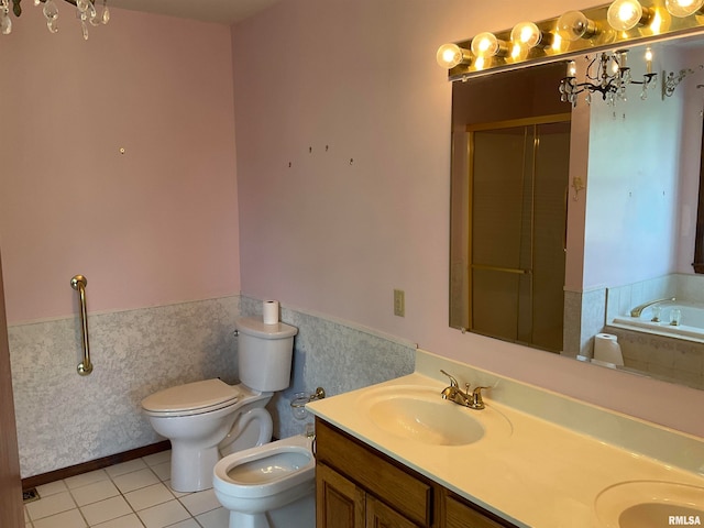 full bathroom with toilet, tile patterned floors, a bidet, vanity, and independent shower and bath