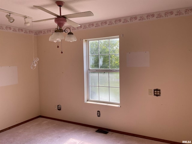 unfurnished room with carpet, ceiling fan, and rail lighting