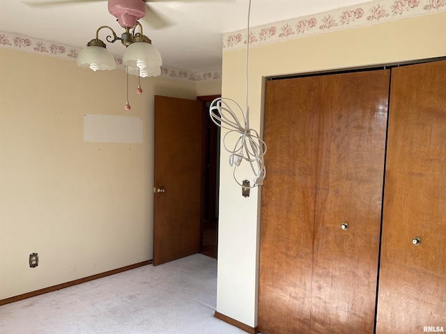 unfurnished bedroom with a closet, ceiling fan, and light carpet