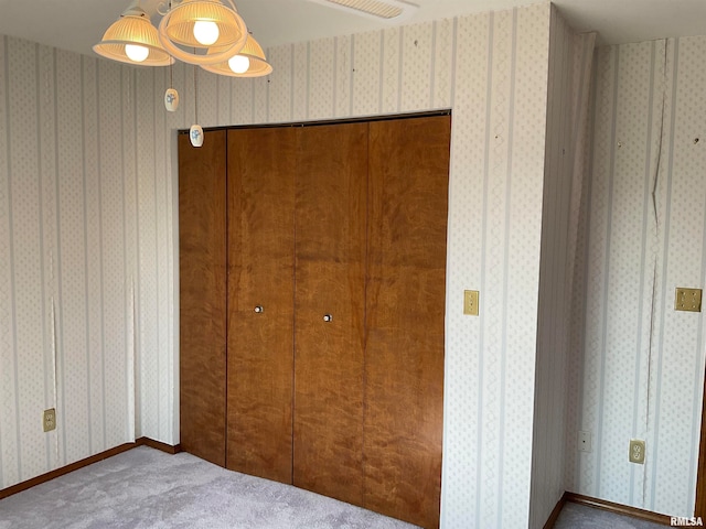 unfurnished bedroom with a closet and carpet flooring