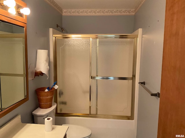 full bathroom featuring vanity, toilet, and bath / shower combo with glass door