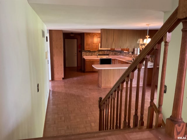 interior space featuring an inviting chandelier and parquet flooring