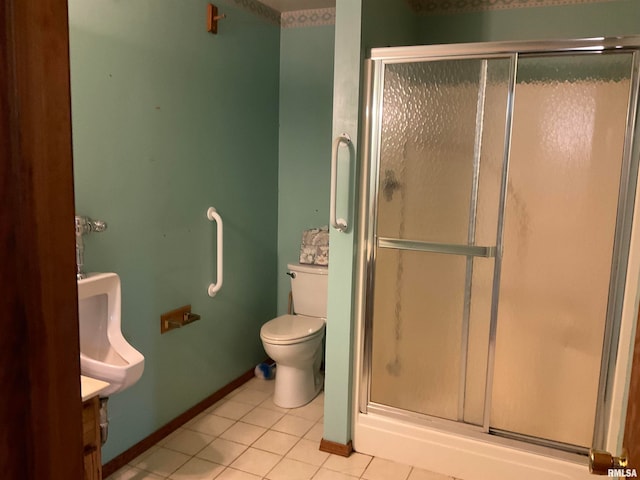 bathroom with tile patterned floors, walk in shower, toilet, and vanity