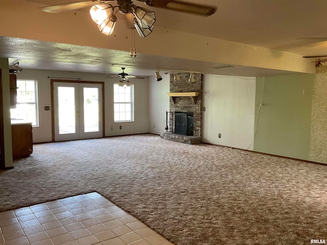 unfurnished living room with light carpet, plenty of natural light, a brick fireplace, and ceiling fan