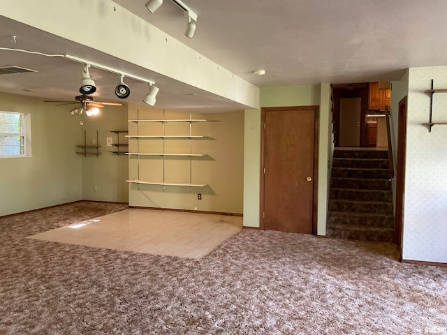 spare room with light carpet and track lighting