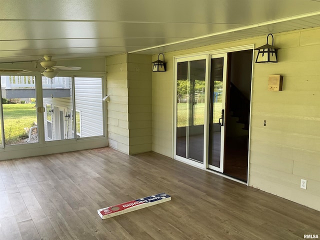 unfurnished sunroom with ceiling fan and a healthy amount of sunlight