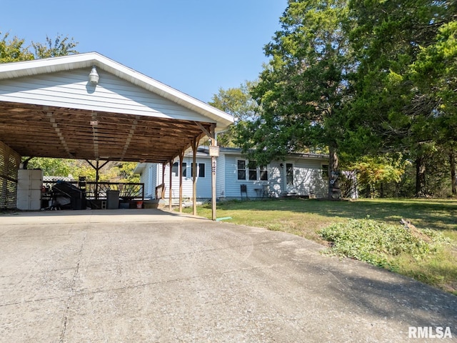 view of front facade with a carport and a front lawn