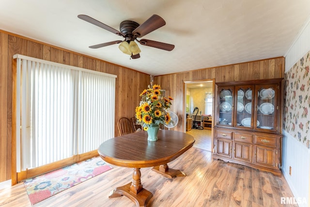 25 Lees Dr, Creal Springs, IL 62922 - dining area featuring wallpapered walls, wood walls, ornamental molding, light wood-style flooring, and ceiling fan