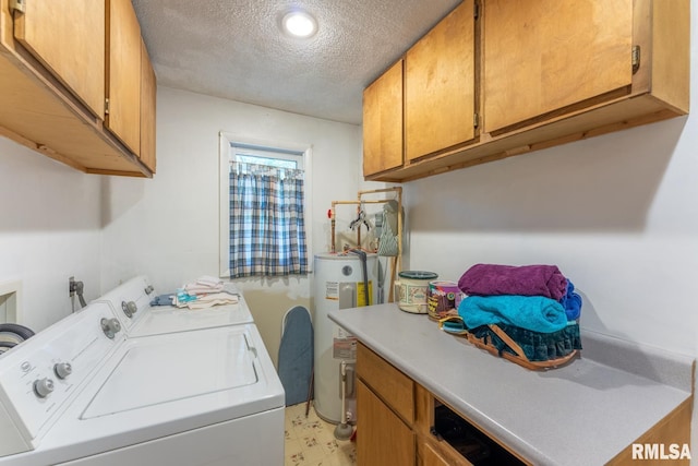 25 Lees Dr, Creal Springs, IL 62922 - clothes washing area featuring washer and clothes dryer, a textured ceiling, water heater, cabinet space, and light floors