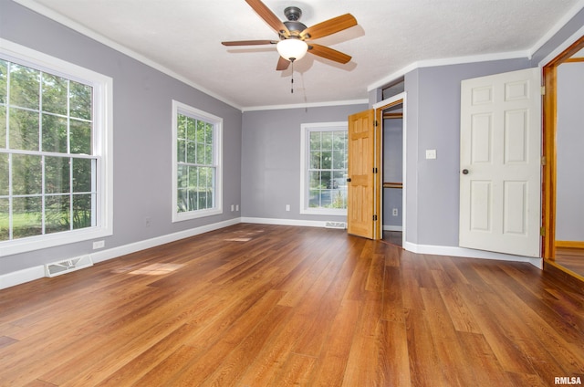 unfurnished room with a textured ceiling, ceiling fan, wood-type flooring, and crown molding