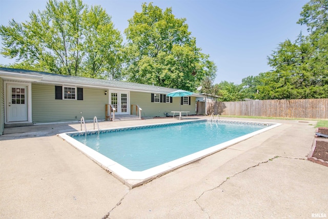 view of pool featuring french doors and a patio