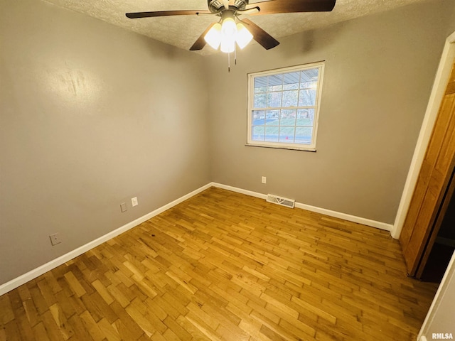 unfurnished room with ceiling fan, a textured ceiling, and light hardwood / wood-style flooring