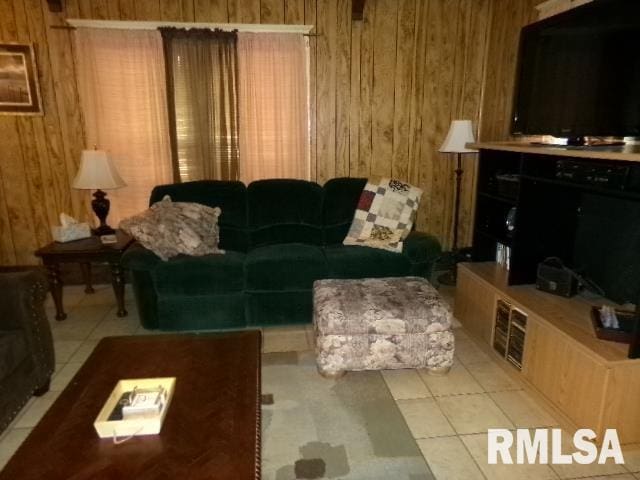 318 Williams St, Rosiclare, IL 62982 - living room with light tile patterned floors and wooden walls