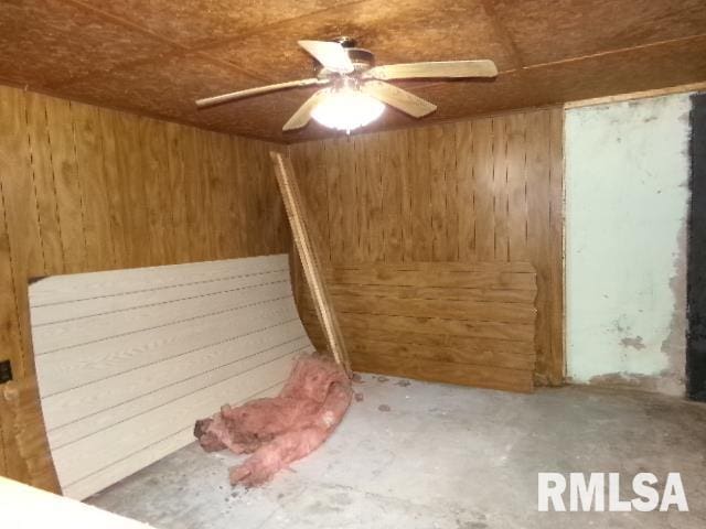 318 Williams St, Rosiclare, IL 62982 - empty room featuring ceiling fan and wood walls