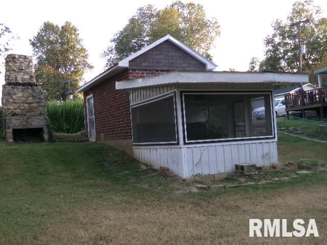 318 Williams St, Rosiclare, IL 62982 - view of side of home with a yard, a sunroom, and a deck