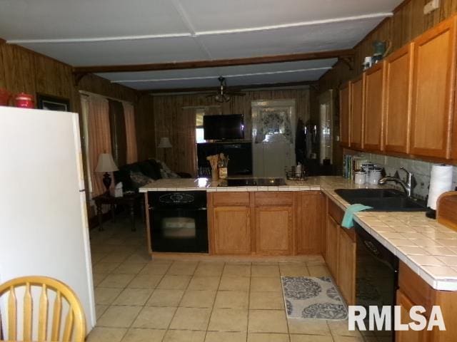 318 Williams St, Rosiclare, IL 62982 - kitchen featuring black appliances, light tile patterned flooring, sink, and tile counters