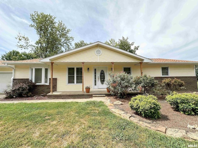 ranch-style home featuring a garage, a porch, and a front lawn