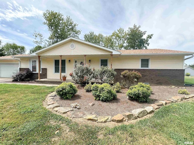 single story home featuring a garage, covered porch, and a front lawn