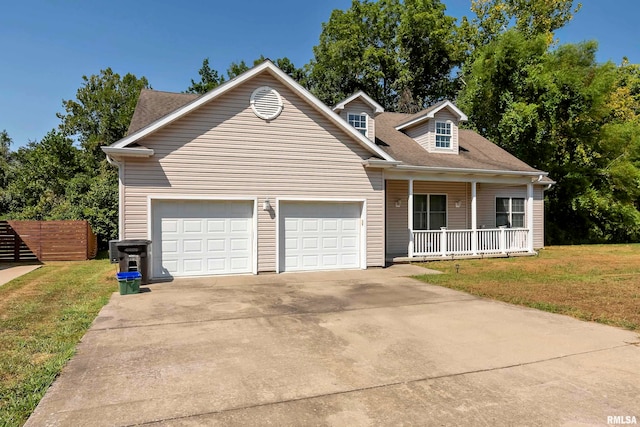 view of front of home with a garage, a front yard, and a porch